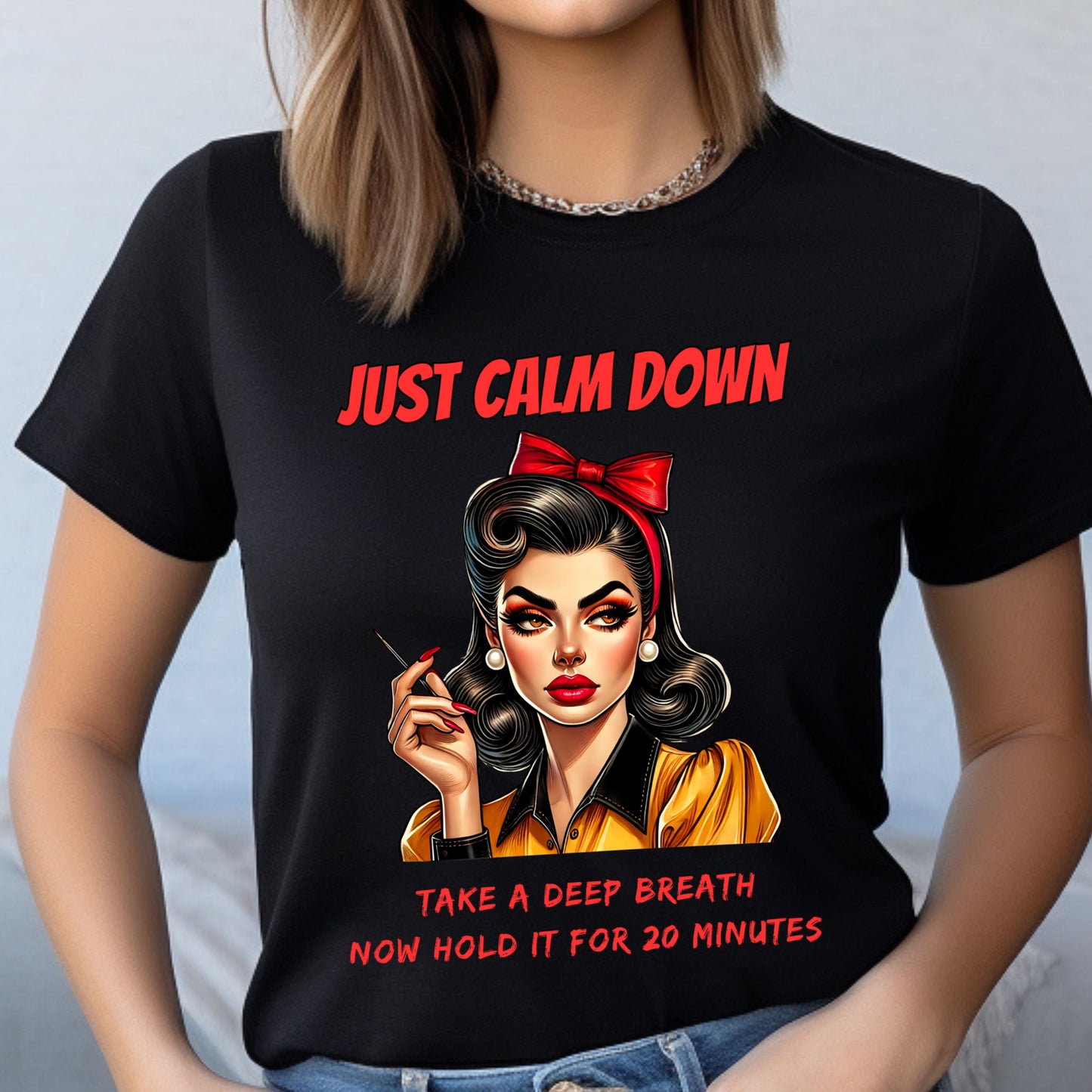 Black t-shirt with a graphic of a woman and text 'Just Calm Down, Take a Deep Breath Now Hold It for 20 Minutes' on a plain background.