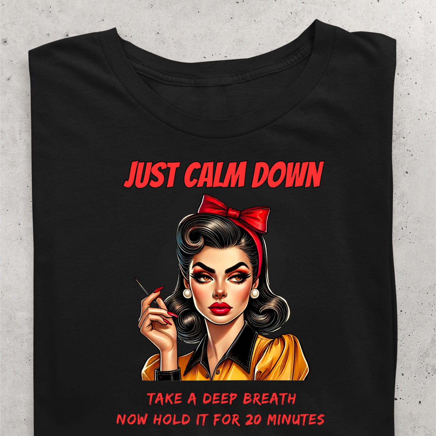 Black t-shirt with a graphic of a woman and text on a concrete surface