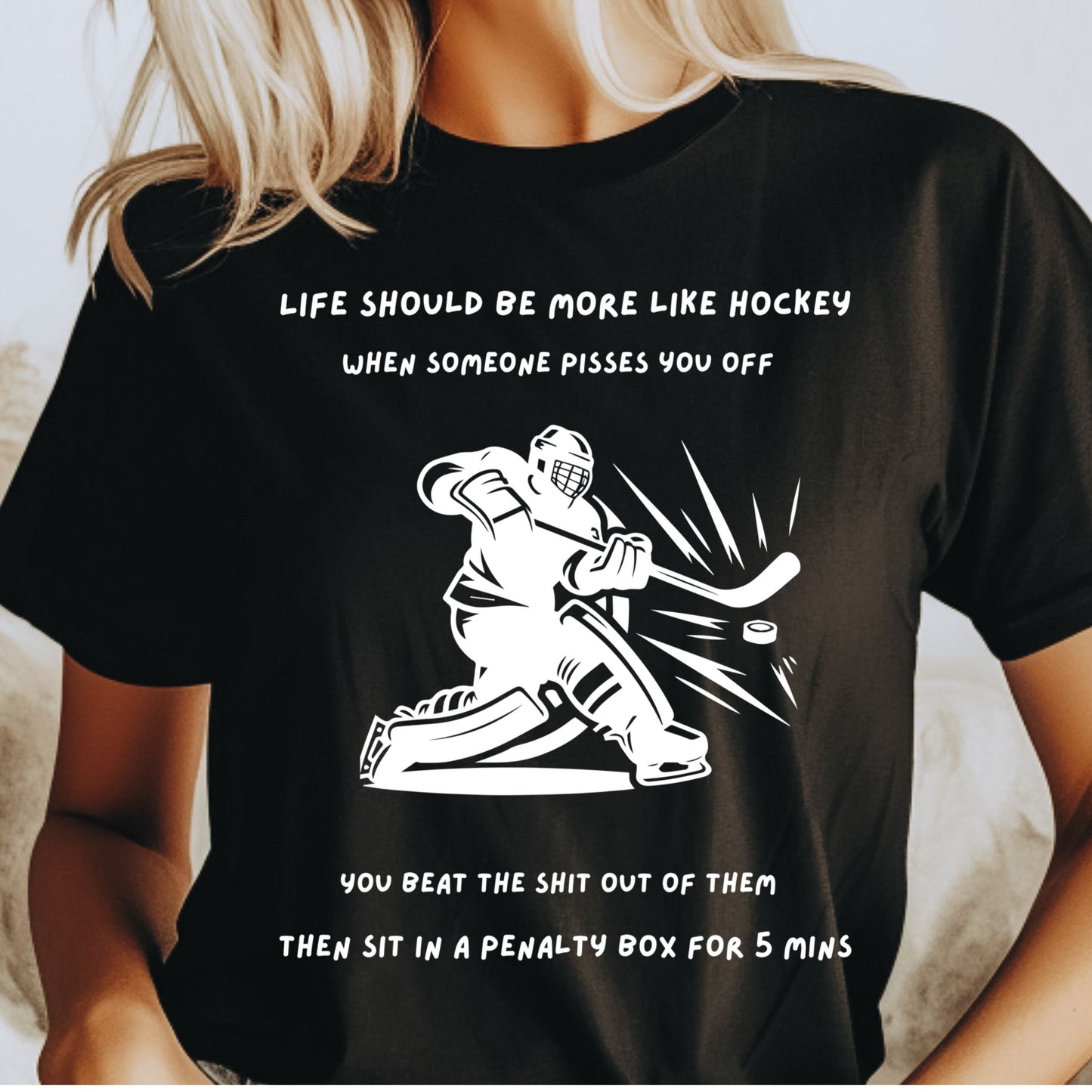 Black t-shirt o female model with hockey graphic and humorous text worn by a person.