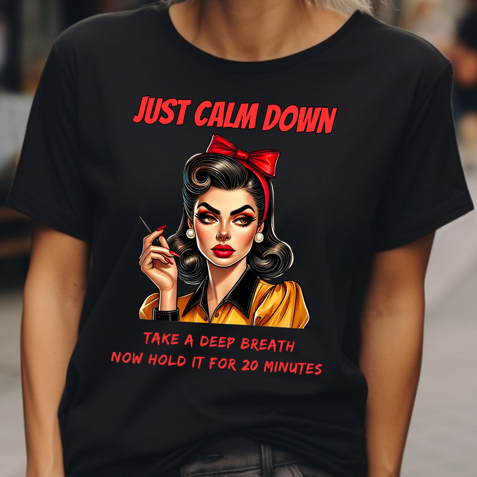 Black t-shirt with a graphic of a woman and humorous text on a blurred background