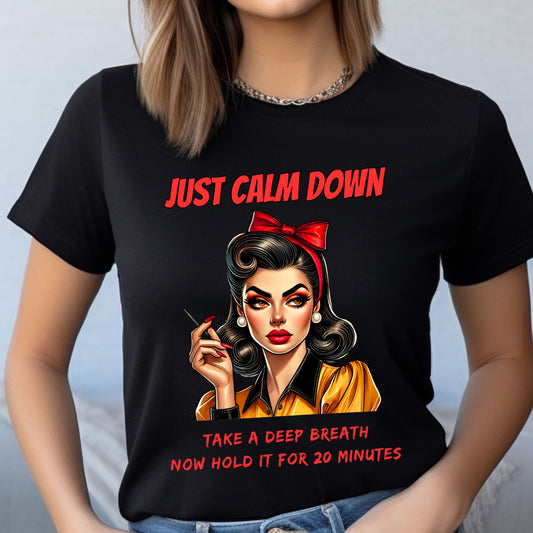 Black t-shirt with a graphic of a woman and text 'Just Calm Down, Take a Deep Breath Now Hold It for 20 Minutes' on a plain background.