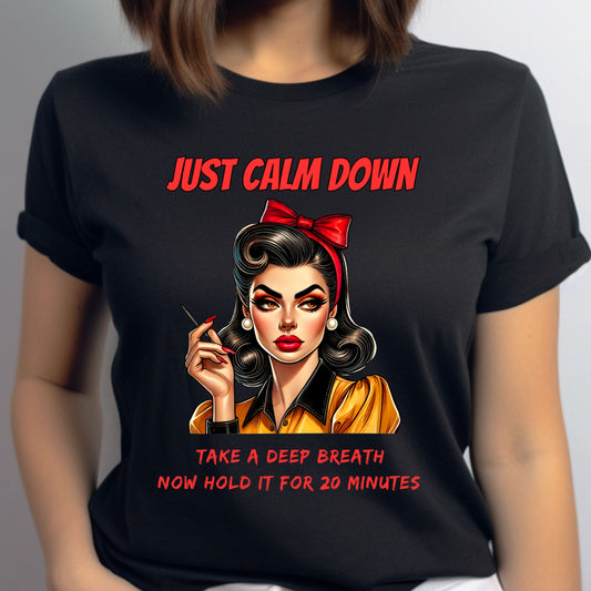 Black t-shirt with a graphic of a woman and text 'Just Calm Down' and 'Take a Deep Breath Now Hold it for 20 Minutes'.
