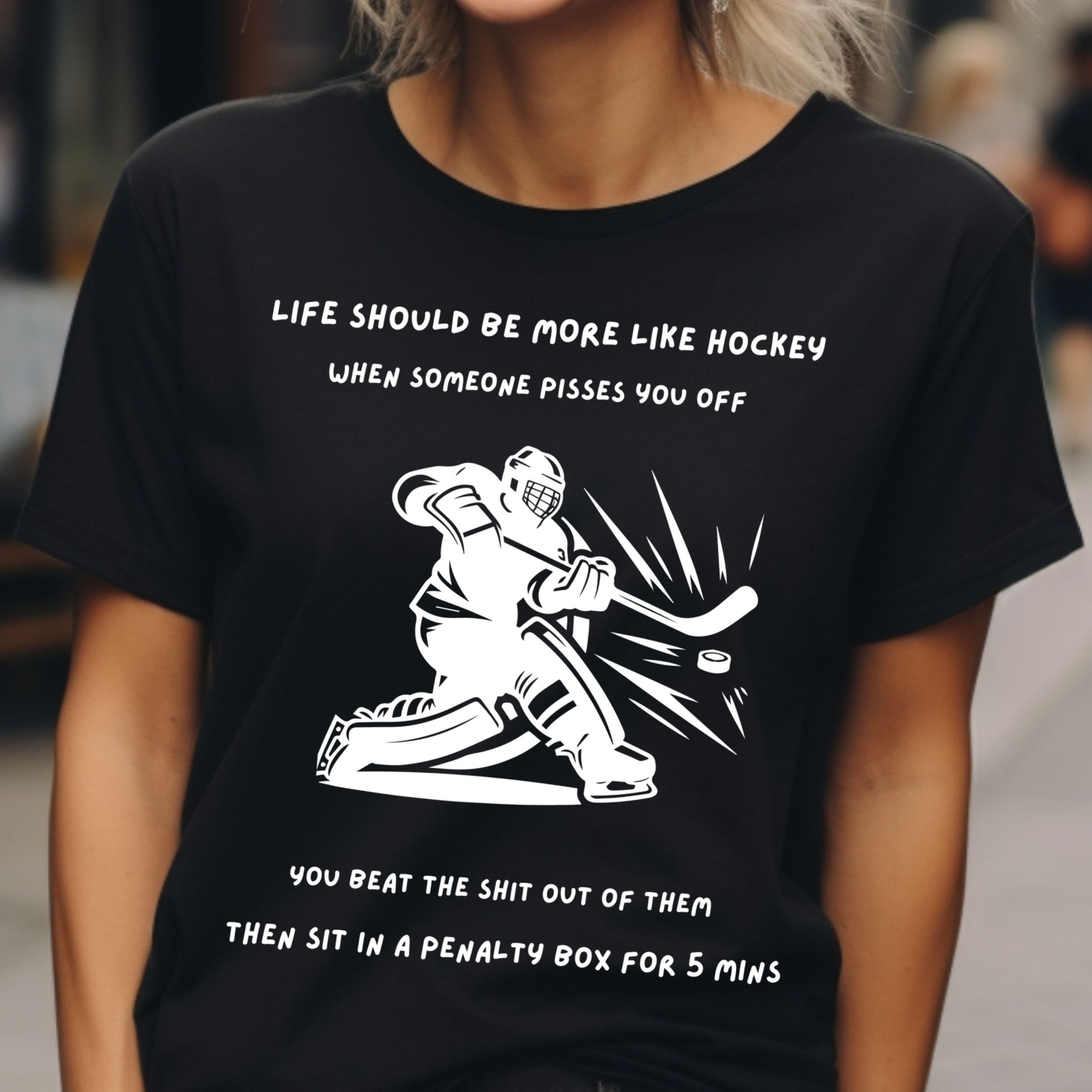Black t-shirt with hockey graphic and humorous text worn by a person.