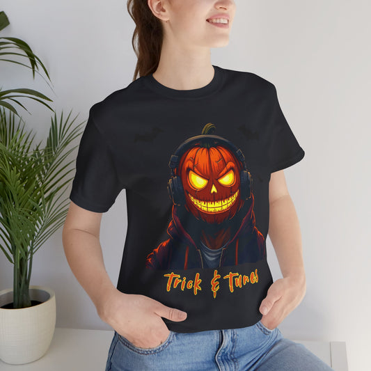 Pumpkin head man with headphones.  Trick & Tunes tshirt text