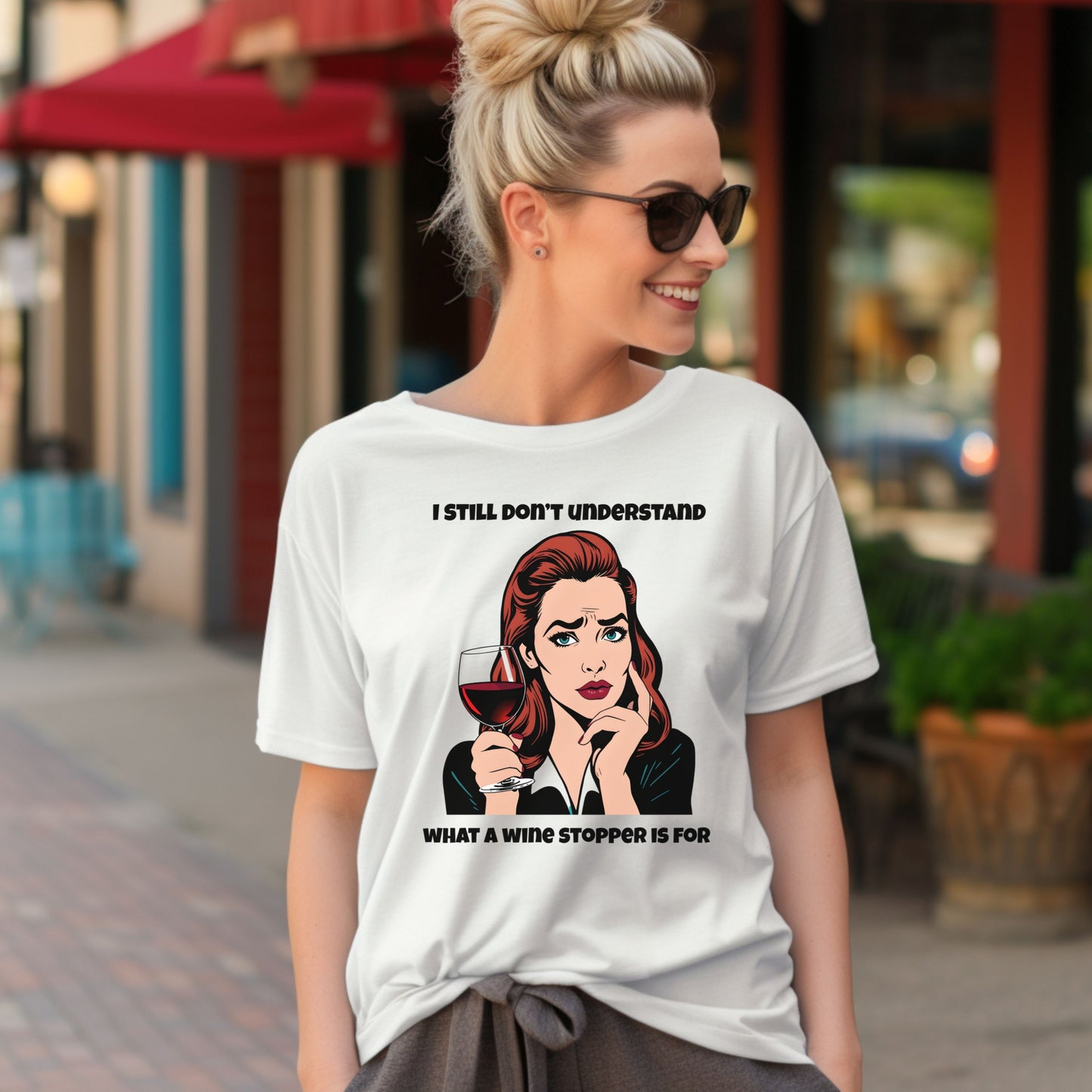 Woman wearing a white t-shirt with a graphic and text on a city street.